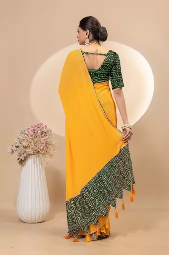 Yellow georgette saree with siroski work and bandhni print pallu and blouse