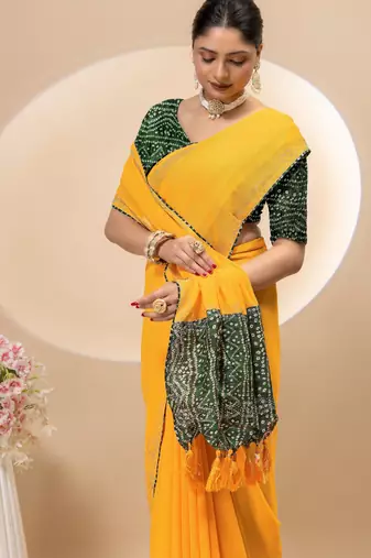 Yellow georgette saree with siroski work and bandhni print pallu and blouse