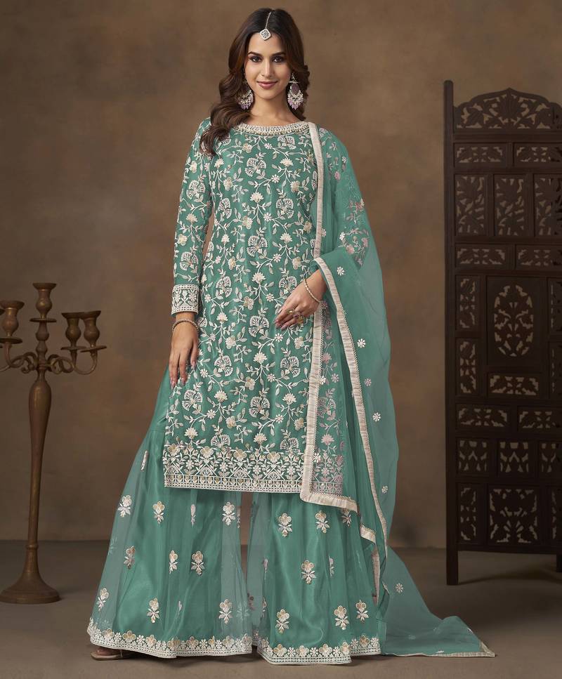 Turquoise net heavy thread embroidery with sequins work palazzo suit