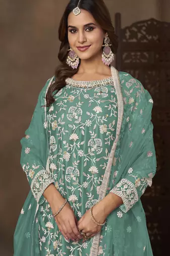Turquoise net heavy thread embroidery with sequins work palazzo suit