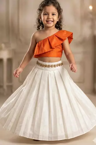 Orange one-shoulder top with ivory skirt