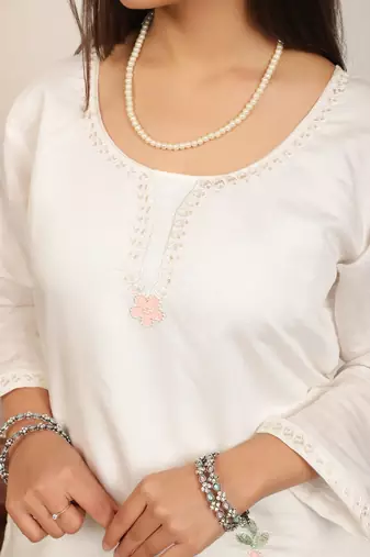 White embroidery work cotton blend kurta trousers with dupatta.