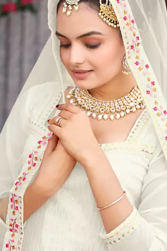  cream ethnic dress material set featuring delicate floral embroidery with skirt & dupatta