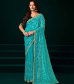 Turquoise net designer saree with sequins embroidery and velvet unstitched blouse