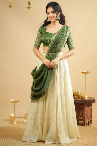 off white silk lehenga with green zari blouse