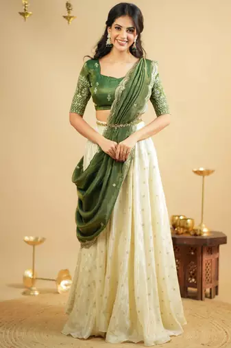 off white silk lehenga with green zari blouse