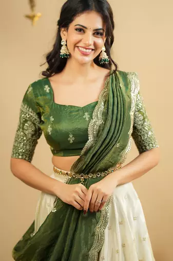 off white silk lehenga with green zari blouse