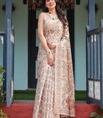 Elegant beige handloom cotton-linen saree with golden zari weave, floral printed pallu & tassel detailing