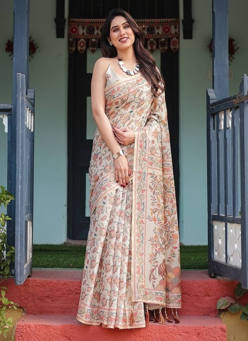 Elegant beige handloom cotton-linen saree with golden zari weave, floral printed pallu & tassel detailing