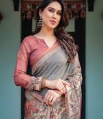 Smoky grey handloom cotton-linen saree with vibrant folk motifs and floral pallu