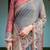 Smoky grey handloom cotton-linen saree with vibrant folk motifs and floral pallu