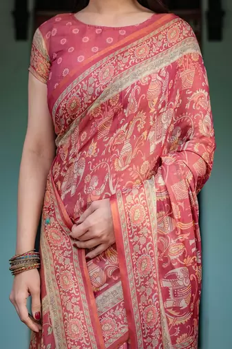 Brick red handloom cotton-linen saree with mythological motifs and floral border