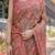 Copper brown handloom cotton-linen saree with floral motifs and vibrant pink accents