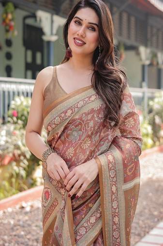 Rust and gold handloom cotton-linen saree with floral motifs and rich zari border