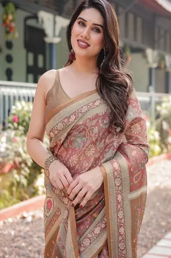 Rust and gold handloom cotton-linen saree with floral motifs and rich zari border