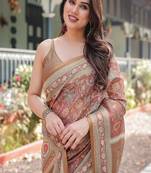 Rust and gold handloom cotton-linen saree with floral motifs and rich zari border