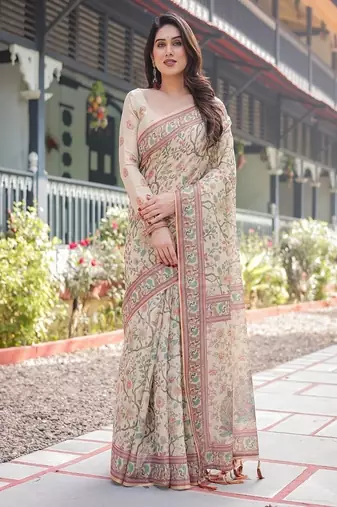 Ivory handloom cotton-linen saree with floral and peacock motifs, zari highlights, and tassel finish