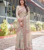 Ivory handloom cotton-linen saree with floral and peacock motifs, zari highlights, and tassel finish