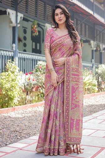 Regal pink handloom cotton-linen saree with floral motifs, golden zari highlights, and tassel detailing