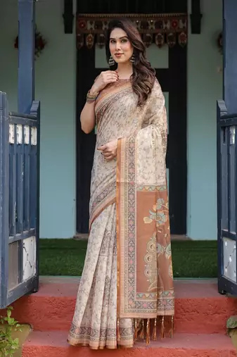 Ivory handloom cotton-linen saree with floral and peacock motifs, zari highlights, and tassel finish