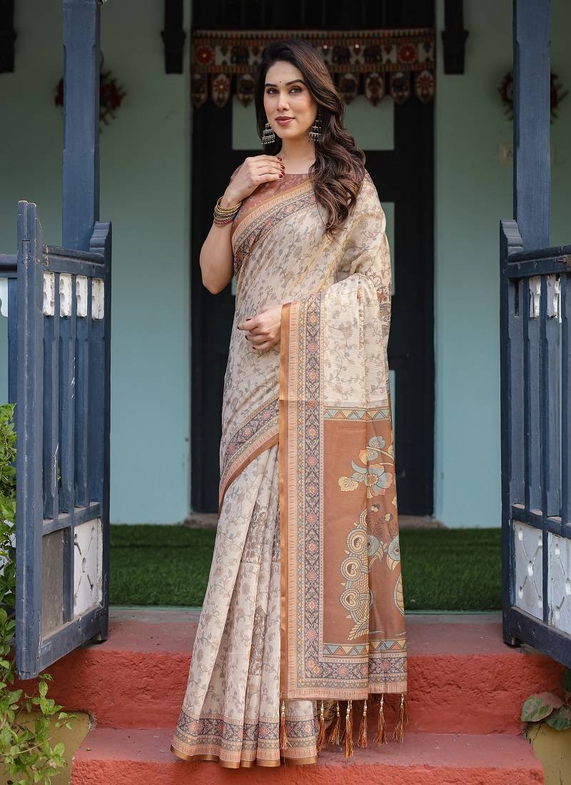 Ivory handloom cotton-linen saree with floral and peacock motifs, zari highlights, and tassel finish