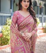Regal pink handloom cotton-linen saree with floral motifs, golden zari highlights, and tassel detailing