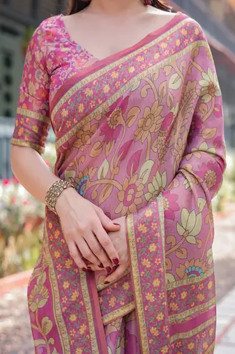 Regal pink handloom cotton-linen saree with floral motifs, golden zari highlights, and tassel detailing