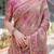 Regal pink handloom cotton-linen saree with floral motifs, golden zari highlights, and tassel detailing