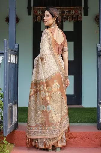 Ivory handloom cotton-linen saree with floral and peacock motifs, zari highlights, and tassel finish