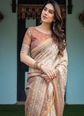 Ivory handloom cotton-linen saree with floral and peacock motifs, zari highlights, and tassel finish 1