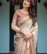 Ivory handloom cotton-linen saree with floral and peacock motifs, zari highlights, and tassel finish