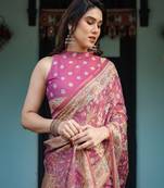 Pink handloom cotton-linen saree with gold floral motifs and peacock pallu