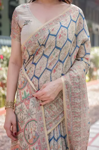 Classic beige handloom cotton-linen saree with madhubani-inspired prints and zari highlights