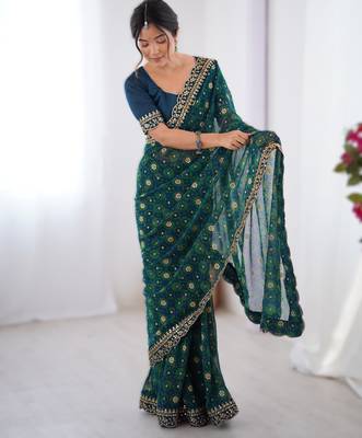 Teal floral printed georgette chiffon saree with foil work & embroidered lace border 1
