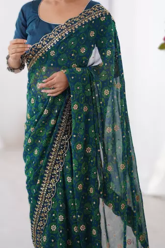 Teal floral printed georgette chiffon saree with foil work & embroidered lace border