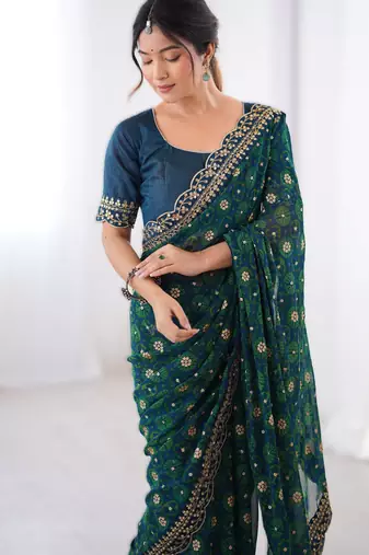 Teal floral printed georgette chiffon saree with foil work & embroidered lace border