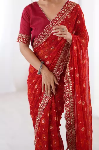 Red floral printed georgette chiffon saree with foil work & embroidered lace border