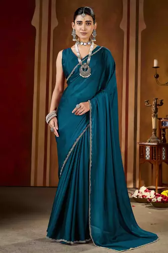 Party wear new rangoli silk rama color saree with blouse and stone lace border
