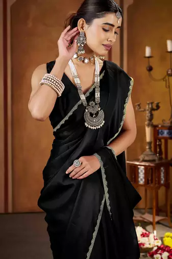 Party wear new rangoli silk black color saree with blouse and stone lace border