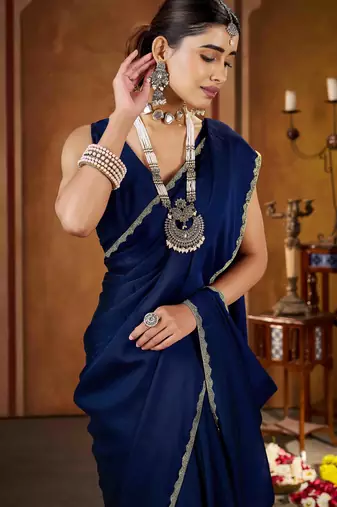 Party wear new rangoli silk navy blue color saree with blouse and stone lace border