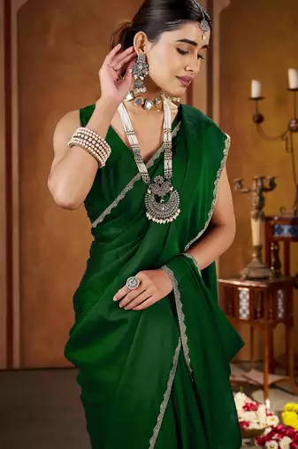 Party wear new rangoli silk green color saree with blouse and stone lace border