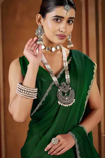 Party wear new rangoli silk green color saree with blouse and stone lace border
