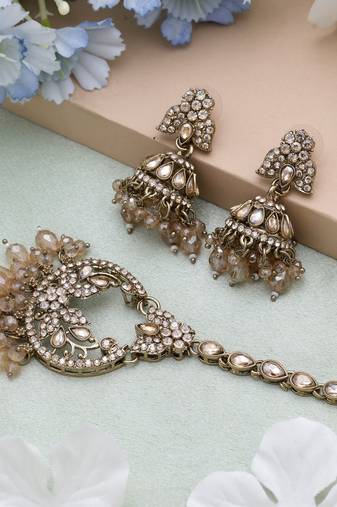 Gold color kundan earrings tikka set