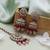 Rani color kundan earrings tikka set
