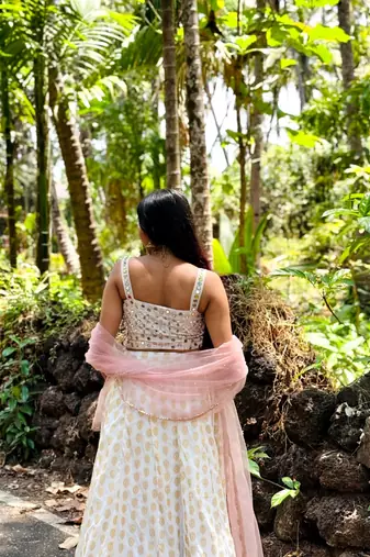 white banarasi georgette lehenga choli with gold motifs