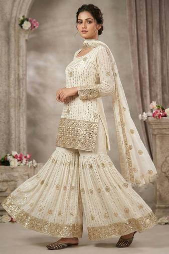 Premium white designer sharara set with heavy golden work