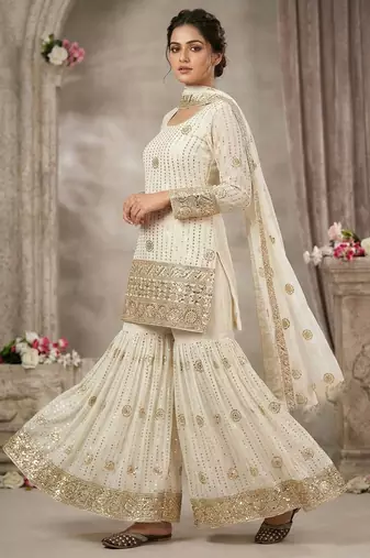 Premium white designer sharara set with heavy golden work