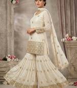 Premium white designer sharara set with heavy golden work