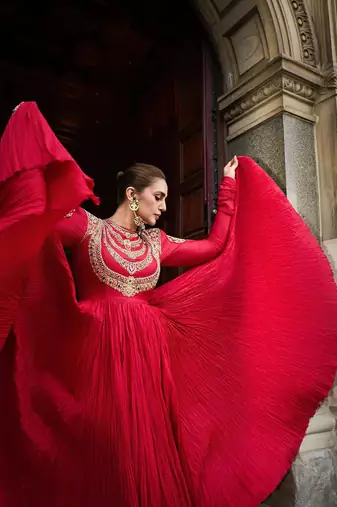 Red designer gown with gold embroidery