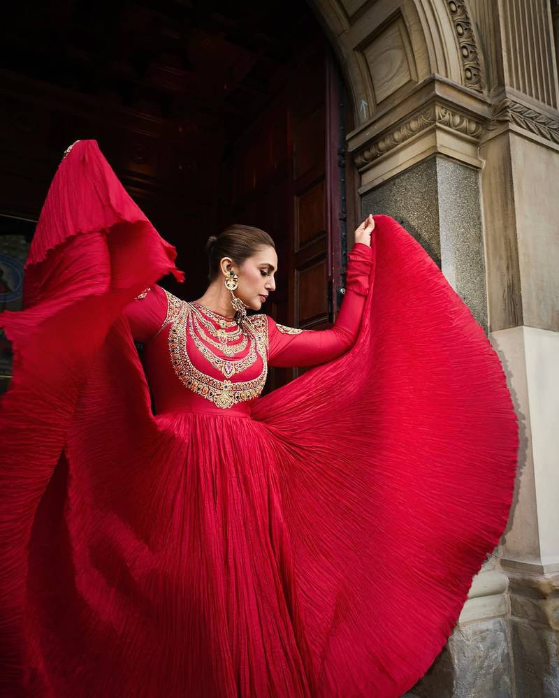 Red designer gown with gold embroidery
